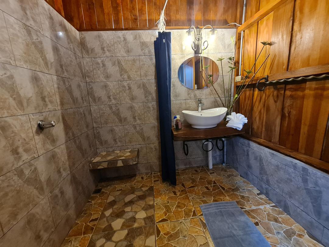 Cabin Eco Container Eco-container cabin's cozy sleeping area with rustic wooden design in La Fortuna.